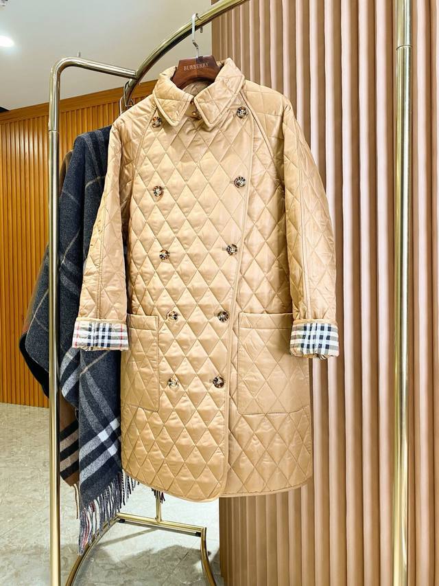 Long diamond-quilted barn coat, a top-selling item from Burberry. This long, qu