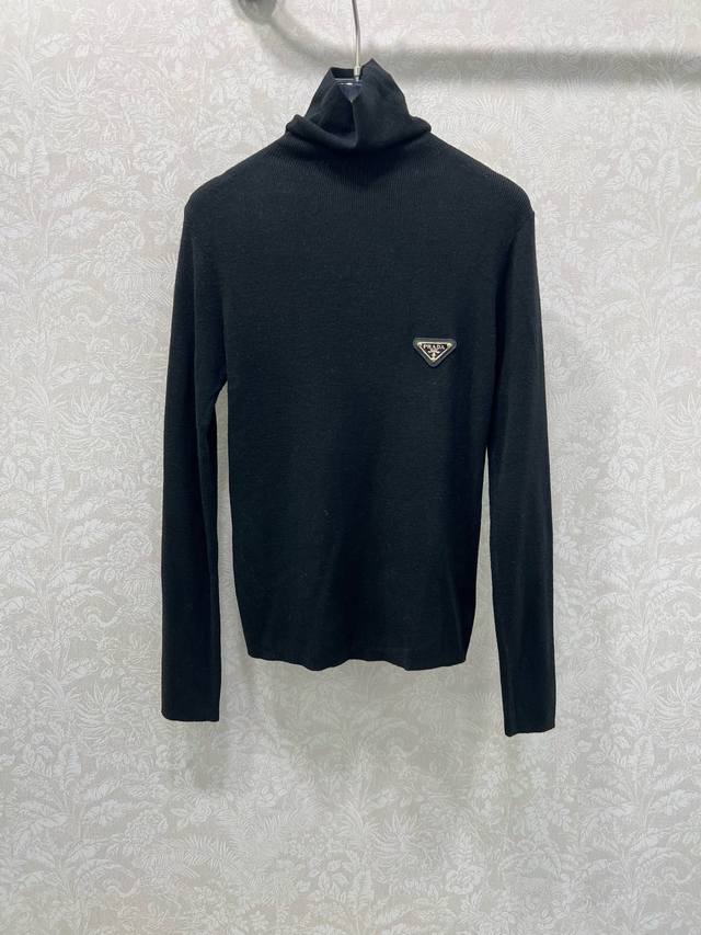 prad*25 New wool turtleneck top with logo and small metal embellishment on the c
