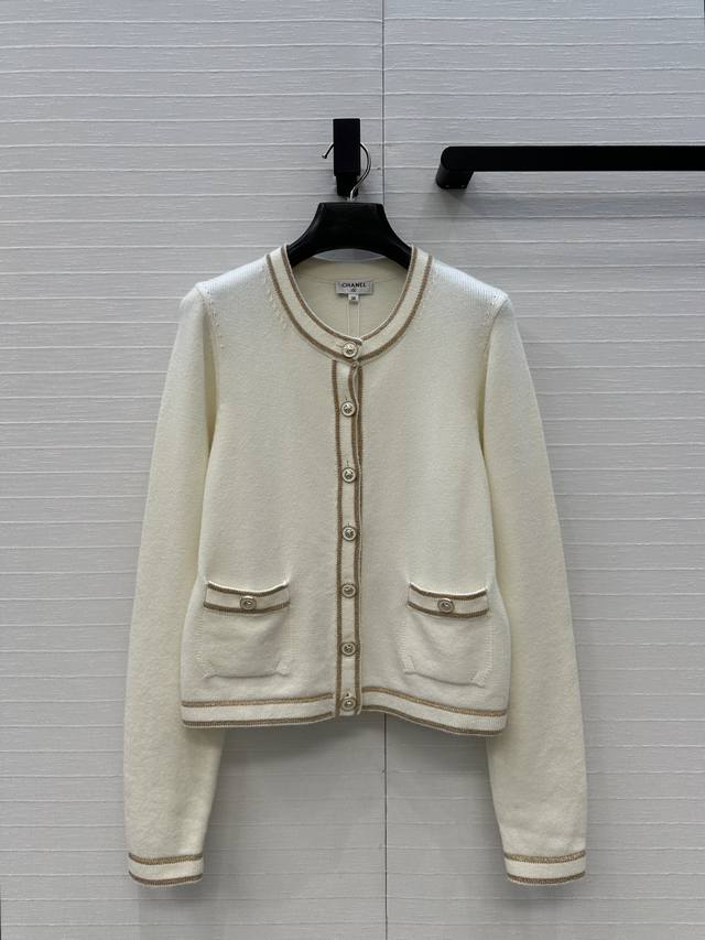 Highly recommend the new Ch*26C! A white and gold knit long-sleeved cardigan wi