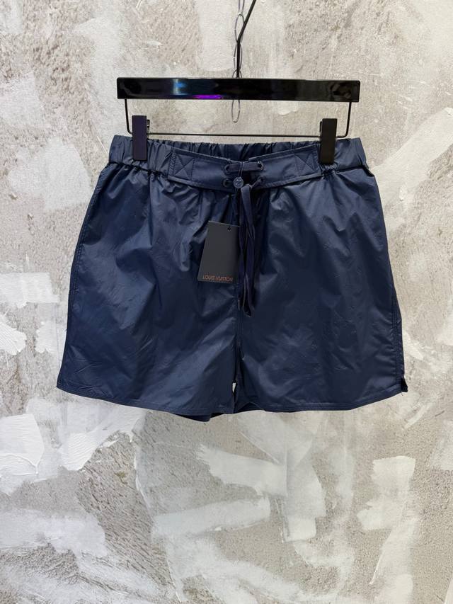 LV 3D Zippered Pocket Beach Shorts, Navy Blue Fabric with Subtle Embossed Logo.