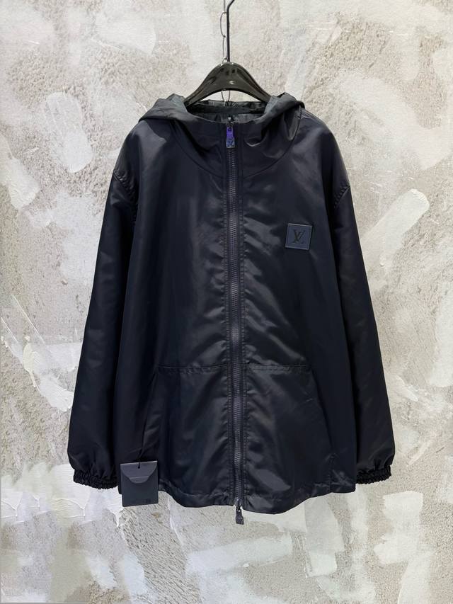 LV Reversible Windbreaker Jacket. One side features a classic leather logo, whil