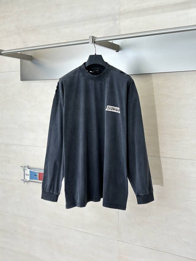 Balenciag* Paris Blcg White-based, printed crew neck long-sleeved garment. Made