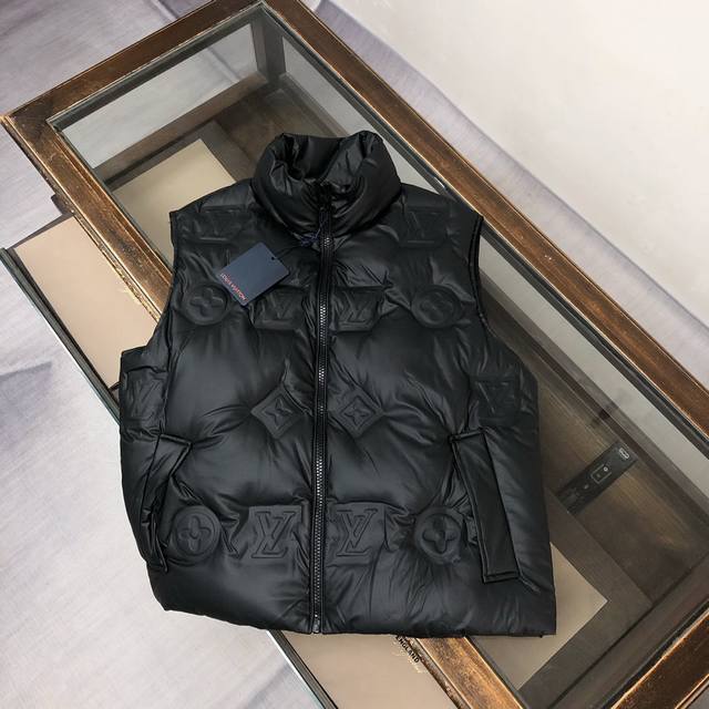 Louis Vuitton LV's classic and timeless short down vest system, a leather down