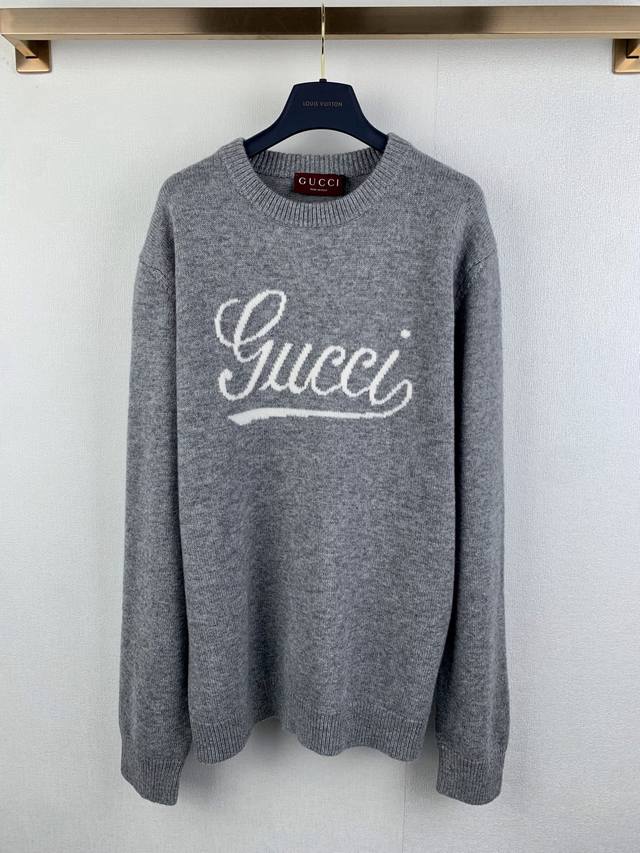 Gucci Embossed Knit Wool Sweater The sweater features a green knit body with a h