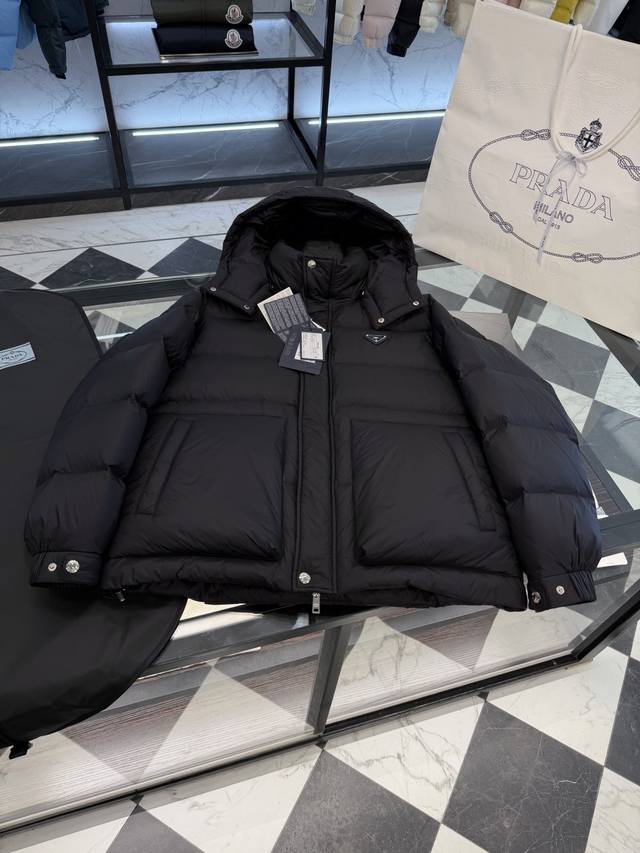 Prada Triangle Badge 3D Quilted Hooded Down Jacket. The hood is detachable and