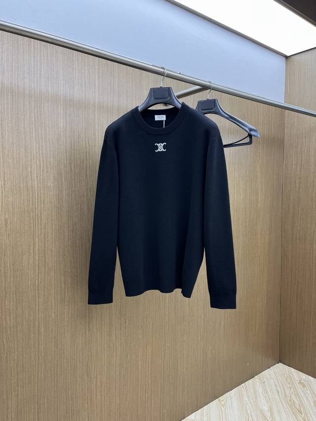This Celine black knit sweater features a classic black and white color scheme