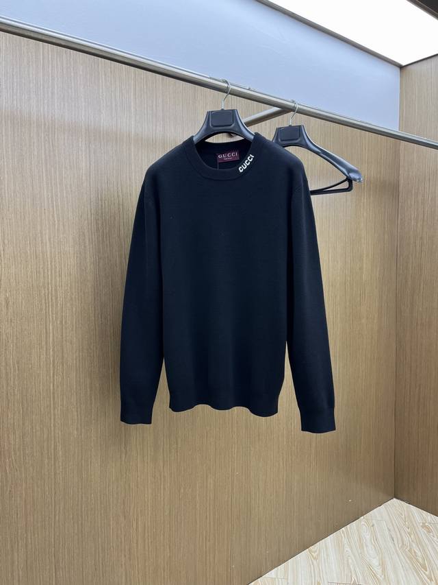 New Gucci black knitwear. A minimalist black top with the Gucci logo subtly hid