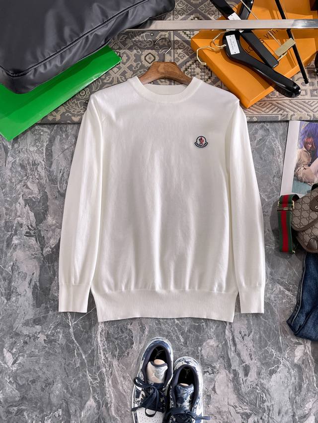 Moncler Crew Neck Sweater, made with a wool blend yarn, offers excellent warmth,