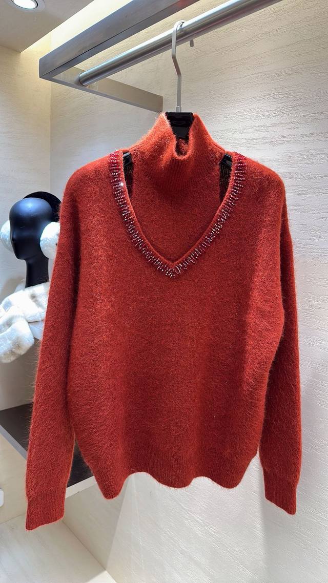 Love at first sight! This Miu Miu raccoon fur layered top features a high neck a