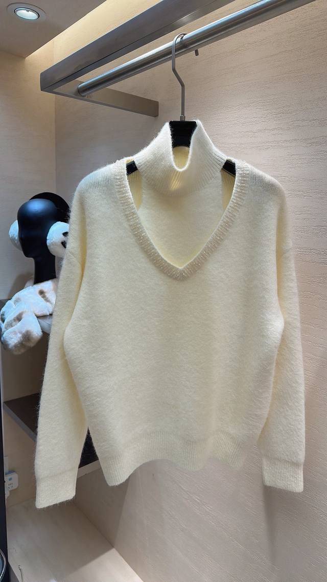 Love at first sight! This Miu Miu raccoon fur layered top features a high neck a