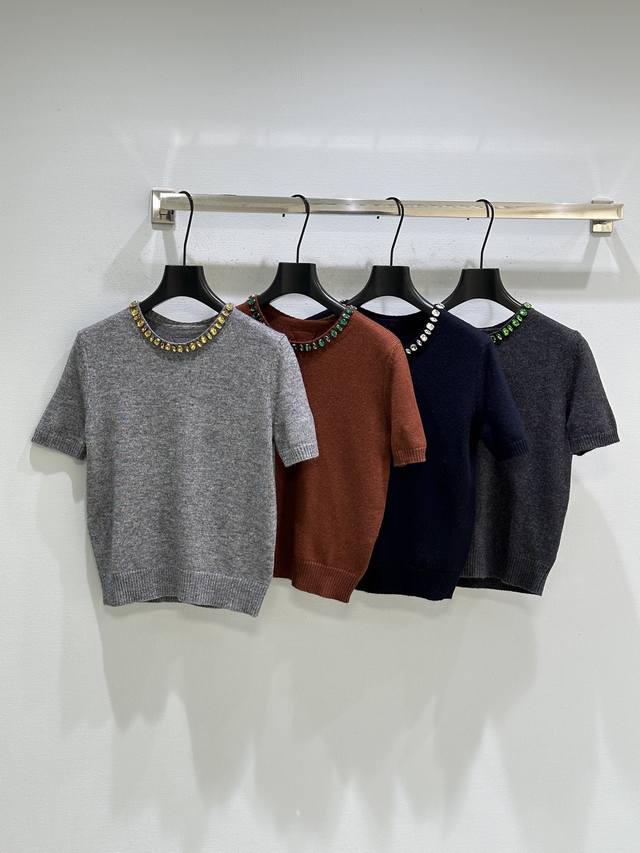 25Ss New Winter Arrival! Jewelry accents adorn this short-sleeved sweater, showc
